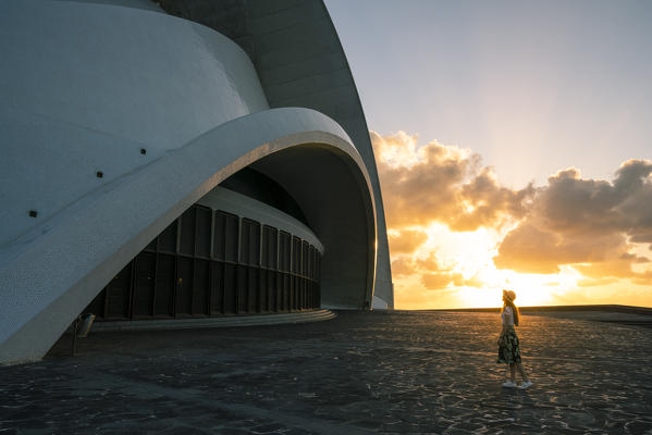 Auditorio de Tenerife at sunrise. Santa Cruz de Tenerife, Tenerife, Canary Islands, Spain. A tourist admiring the view