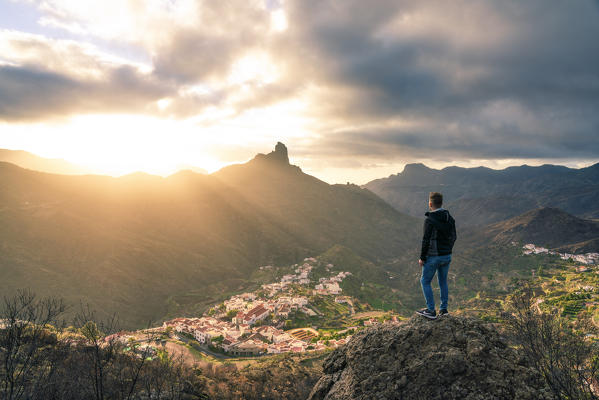 Roque Bentayga and Tejeda village at sunset. A tourist admiring the view. Tejeda, Las Palmas, Gran Canaria, Canary Islands, Spain, Europe