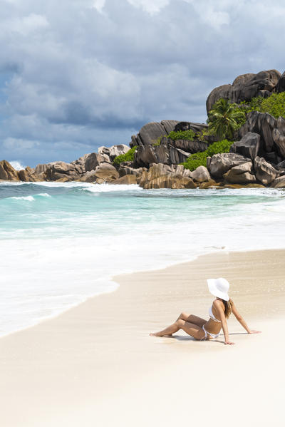 Beautiful woman relaxing on the beach. La Digue island, Seychelles, Africa  