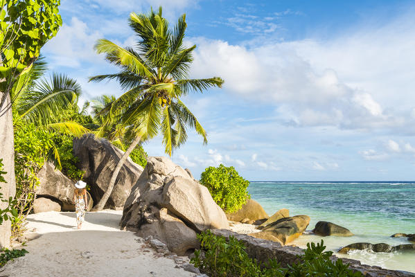Woman strolling along the footpath near Anse Source d'Argent. La Digue, Seychelles, Africa