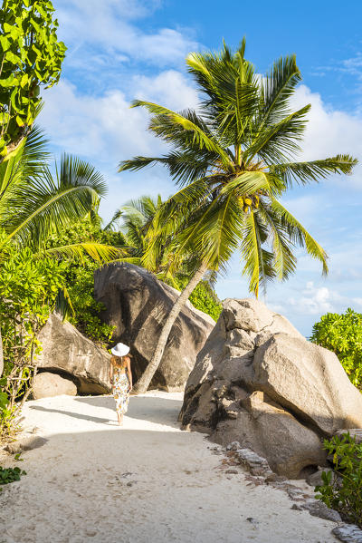 Woman strolling along the footpath near Anse Source d'Argent. La Digue, Seychelles, Africa