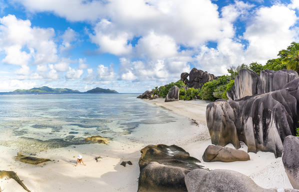 Beautiful young woman relaxing on Anse Source d'Argent beach. La Digue island, Seychelles, Africa  