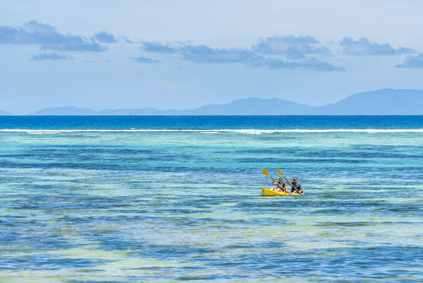 Tourists canoeing in la Digue, Seychelles, Africa