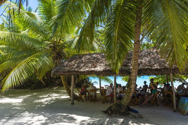 People eating out at the restaurant on Anse Lazio beach. Praslin island, Seychelles, Africa
