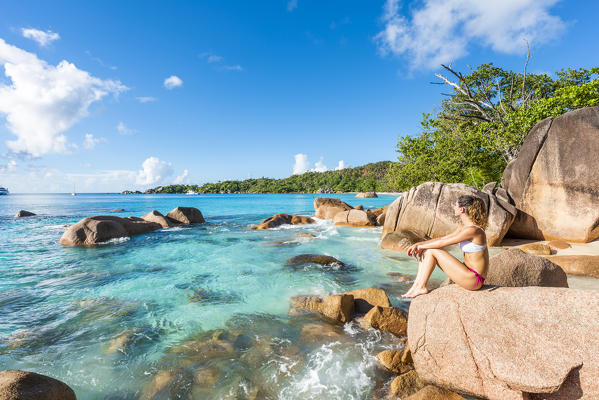 A beautiful woman relaxing on the beach. Anse Lazio, Praslin, Seychelles, Africa (MR)