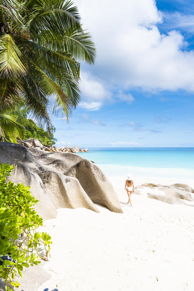 Beautiful woman strolling along Anse Georgette beach. Praslin island, Seychelles, Africa