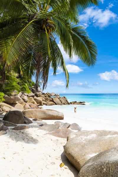 Beautiful woman strolling along Anse Georgette beach. Praslin island, Seychelles, Africa