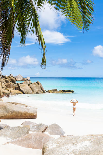 Beautiful woman enjoys the sun on Anse Georgette beach. Praslin Island, Seychelles, Africa (MR)