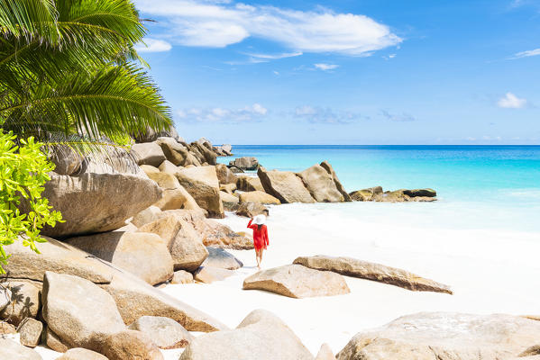 Beautiful woman strolling along Anse Georgette beach. Praslin island, Seychelles, Africa (MR)