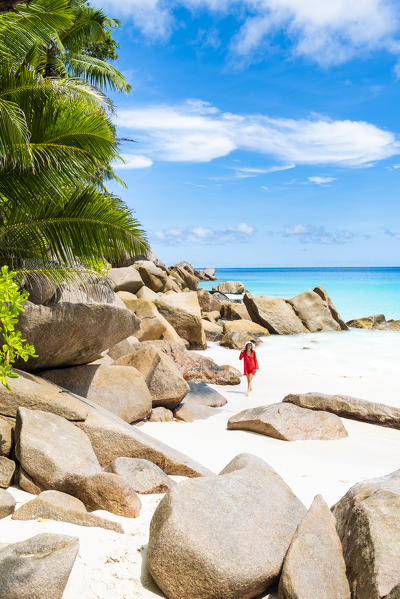 Beautiful woman strolling along Anse Georgette beach. Praslin island, Seychelles, Africa (MR)