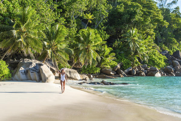 Beautiful woman strolling along Anse Georgette beach. Praslin island, Seychelles, Africa (MR)