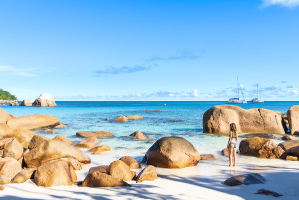 A beautiful woman admiring the view on Anse Lazio beach, Praslin, Seychelles, Africa (MR)