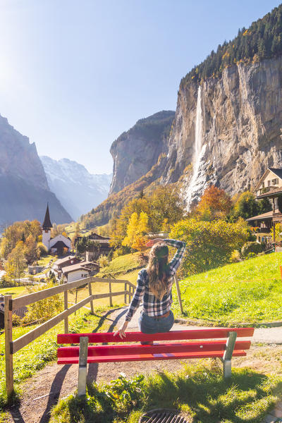 A young woman admires Lauterbrunnen village. Lauterbrunnen, Canton of Bern, Switzerland, Europe