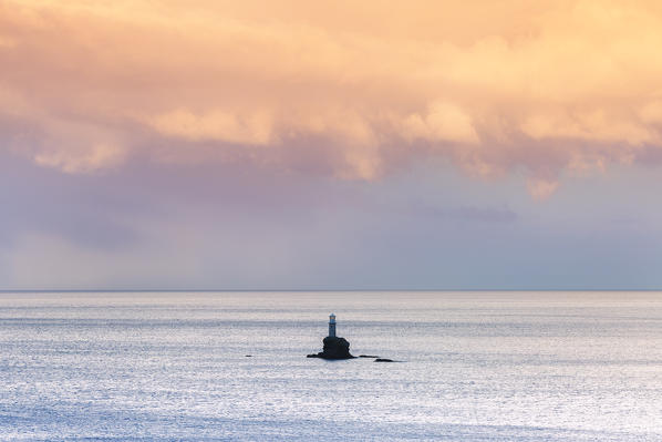 The offshore Tourlitis lighthouse at a cloudy sunset, Andros, Cyclades Archipelago, Greece, Europe