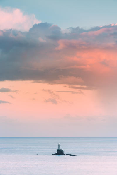 The offshore Tourlitis lighthouse at a cloudy sunset, Andros, Cyclades Archipelago, Greece, Europe