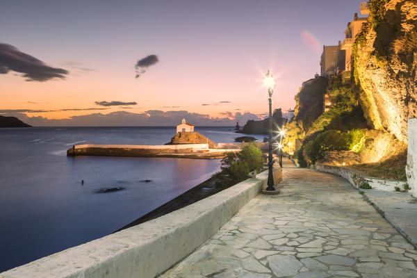 A street of Andros village at dawn with St. Thalassini church in the background, Andros, Cyclades Archipelago, Greece, Europe