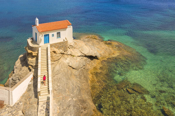 A tourist visiting St. Thalassini church, Andros, Cyclades Archipelago, Greece, Europe