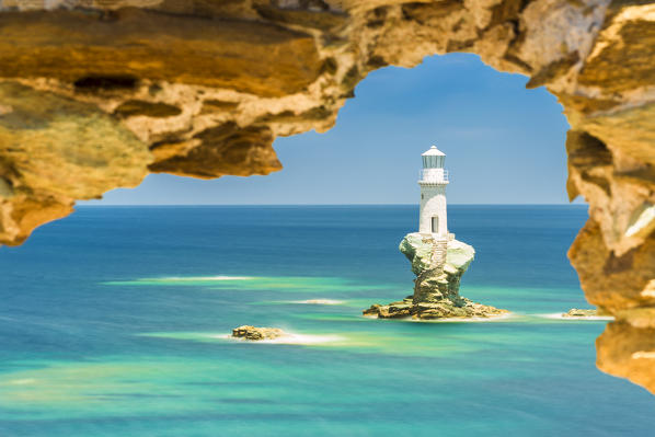 Tourlitis lighthouse framed in a rock window, Andros, Cyclades Archipelago, Greece, Europe