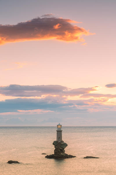 The offshore Tourlitis lighthouse at a cloudy sunset, Andros, Cyclades Archipelago, Greece, Europe