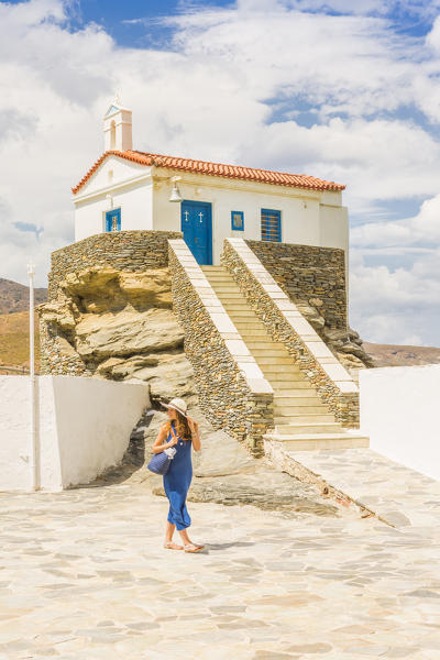 Young woman in a blue dress walking near St, Thalassini Church, Andros, Cyclades archipelago, Greece, Europe