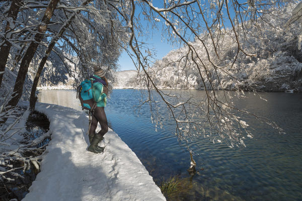 Woman visiting Plitvice Lakes National Park in winter, Plitvicka Jezera, Lika and  Senj County, Croatia