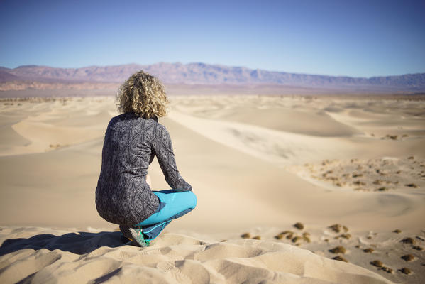 Girl admiring Mesquite Flat Sand Dunes at Death Valley National Park, Inyo County, California, North America, USA