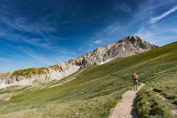 Trekker walking towards Gran Sasso, Campo Imperatore, L'Aquila province, Abruzzo, Italy, Europe