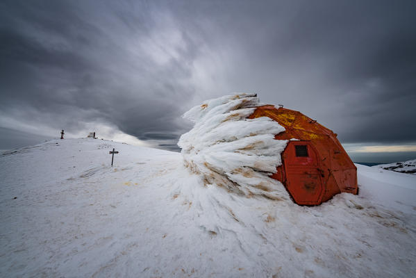 Bivacco Pelino covered with ice and the summit of Monte Amaro, Maiella, L'Aquila province, Abruzzo, Italy, Europe