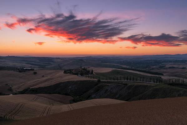 Red clouds over farm house in Tuscany, Asciano, Crete Senesi, Siena province, Tuscany, Italy