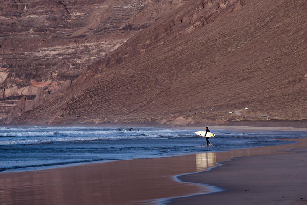 Surfer on Famara beach,  Lanzarote, Canary island, Spain, Europe