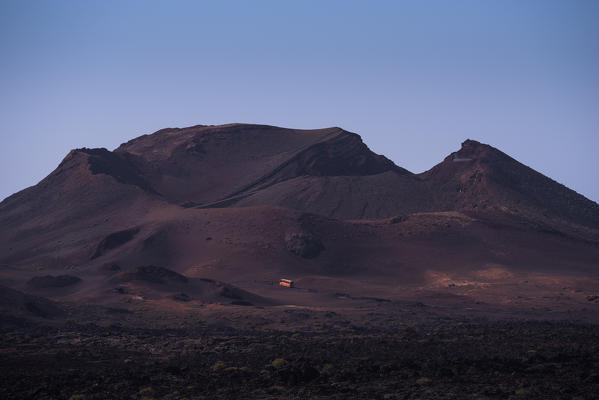 A touristic bus in Timanfaya National Park, Lanzarote, Canary island, Spain, Europe