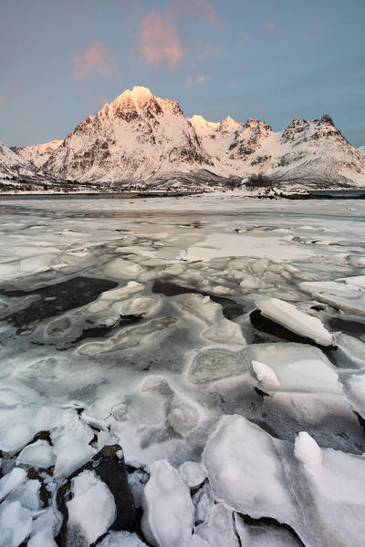 last ray of sunshine in a winter sunset, Austnesfjorden, Lofoten island, Northern Norway, Europe
