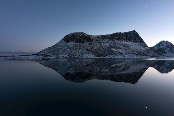 Mountain at mirror in Voiepollen in winter day, Lofoten island, Northern Norway, Europe
