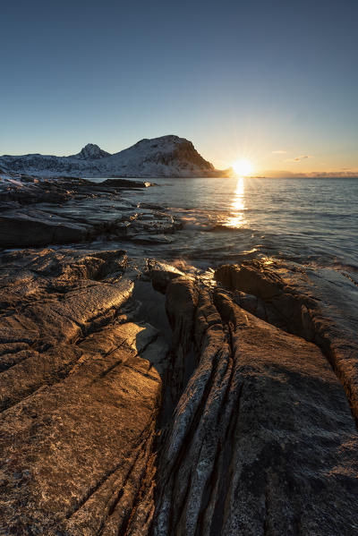 Winter sunset on the rocks around Haukland beach, Lofoten island, Northern Norway, Europe