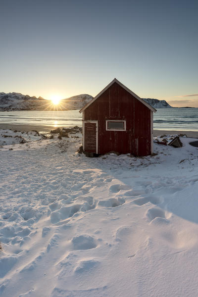 The iconic Rorbuer at Ramberg beach during winter sunset, Lofoten Islands, Northern Norway, Europe