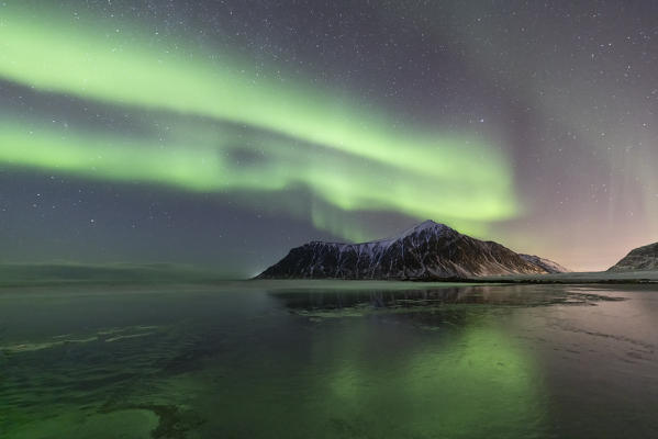A magical night whit Aurora borealis at Flakstad beach, Lofoten Islands, Northern Norway, Europe