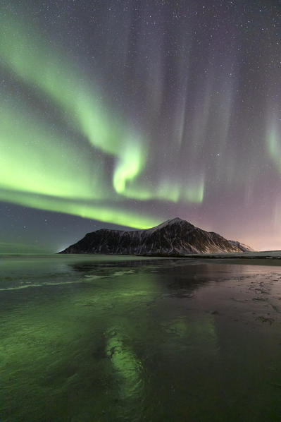 A magical night whit Aurora borealis at Flakstad beach, Lofoten Islands, Northern Norway, Europe
