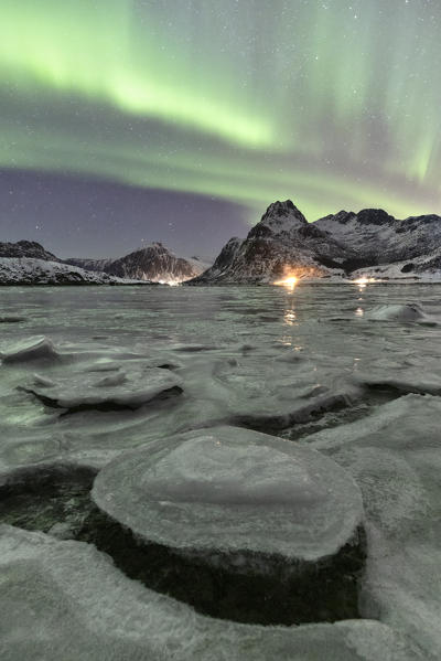 A magical night whit Aurora borealis around Flakstad beach, Lofoten Islands, Northern Norway, Europe