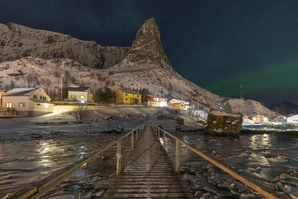 The iconic Hammmarskaftet mountain in Reine village, whit Aurora borealis, Lofoten Islands, Northern Norway, Europe