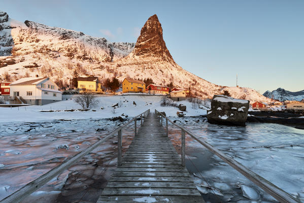 The iconic Hammmarskaftet mountain in Reine village at sunrise in winter day, Lofoten Islands, Northern Norway, Europe