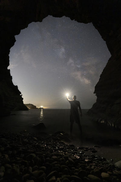 one person admiring the milkyway from the cave, over the island of Palmaria, Porto Venere, La Spezia province, Liguria district, Italy, Europe