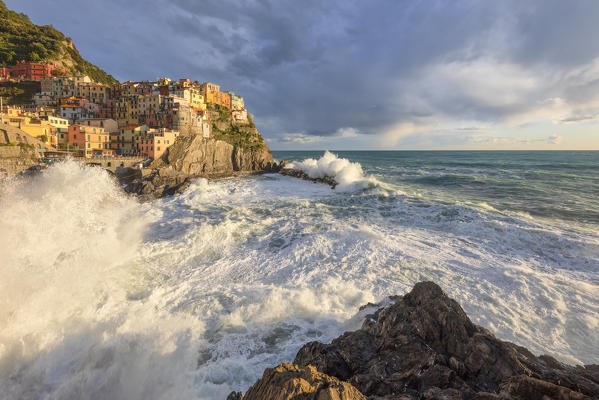 a strong storm hits the village of Manarola during a beautiful winter sunset, UNESCO World Heritage Site, National Park of Cinque Terre, municipality of Riomaggiore, La Spezia province, Liguria district, Italy, Europe