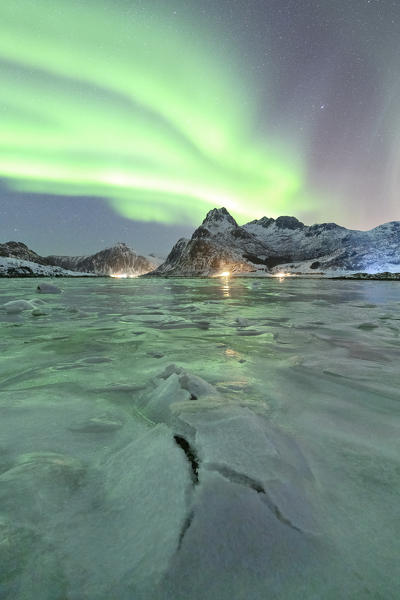 the Northern Lights draw their magic in the sky, illuminating Flakstapollen, municipality of Flakstad, Flakstadoya, Nordland, Lofoten islands, Norway, Scandinavia, Europe
