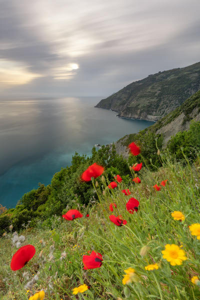 a long exposure to capture a cloudy sunset on the cliffs of Riomaggiore, Cinque Terre national park, municipality of Riomaggiore, La Spezia province, Liguria district, Italy, Europe