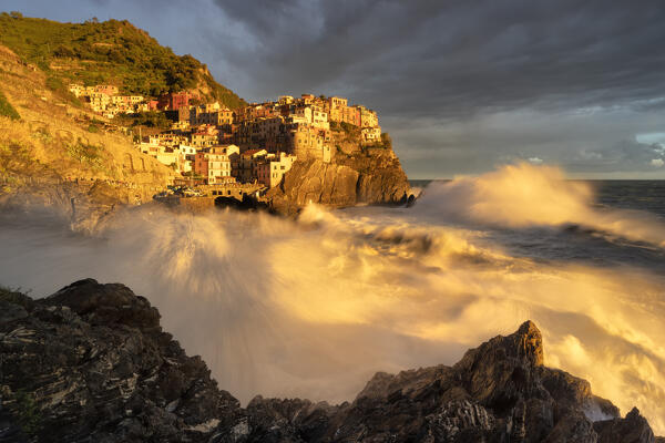 a long exposure to capture the autumn sunset in Manarola during a strong storm, National Park of Cinque Terre, municipality of Riomaggiore, UNESCO WORLD HERITAGE SITE, La Spezia province, Liguria district, Italy, Europe