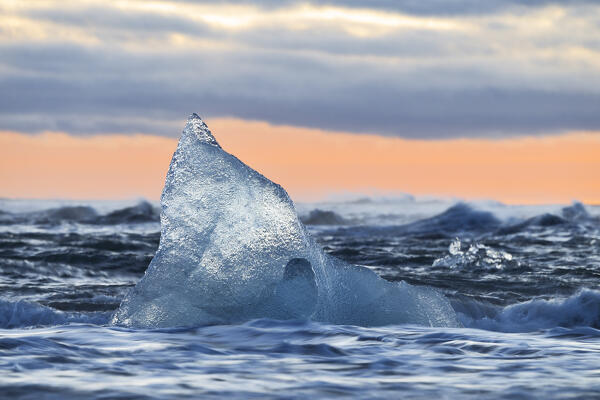a block of ice at Diamond Beach taken during a winter sunset, Jokusarlon Glacier Lagoon, Austurland, Iceland, Europe
