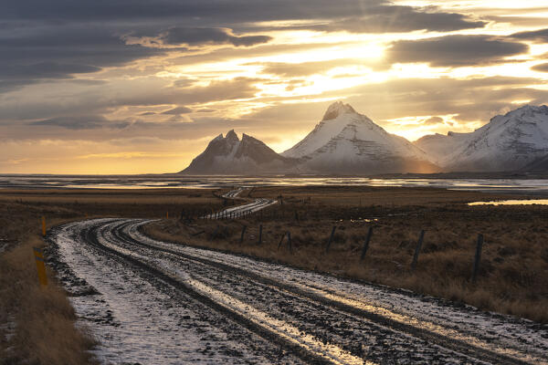 An off road illuminated by an warm sunset, Vestrahorn mountain, Austurland, Southern Iceland, Europe
