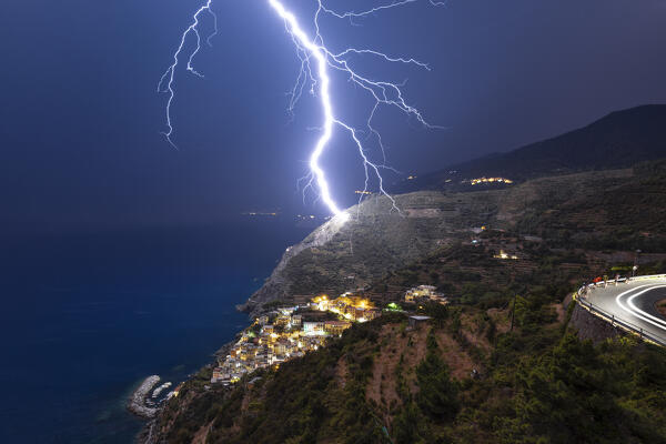 lightning strikes the vineyards of Riomaggiore during an summer night, National Park of Cinque Terre, Riomaggiore, La Spezia, Liguria, Italy, Europe