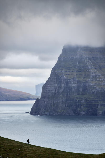 one person walk on the cliffs in the Kalsoy island during an autumn cloudy day, Faroe Islands, Denmark, Scandinavia