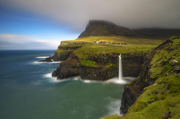 Mulafossur waterfall and the little village of Gasadalur, Vagar island, Faroe Islands, Denmark, Europe